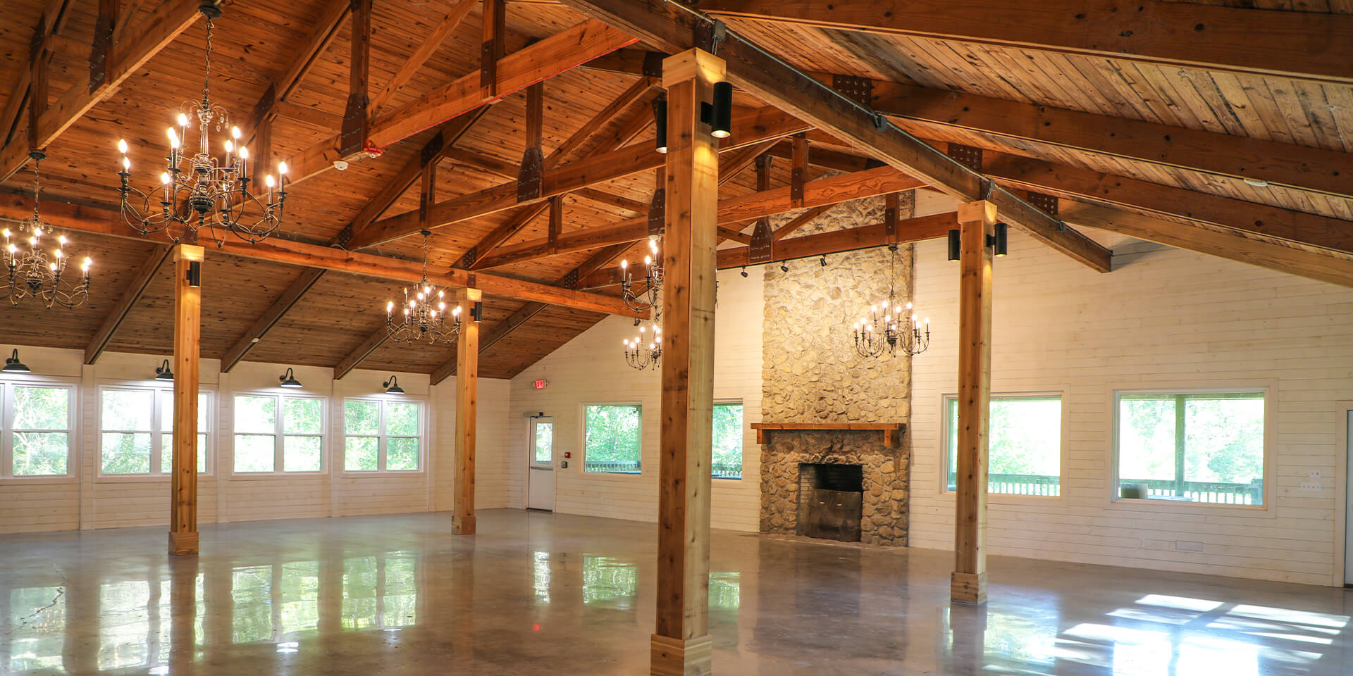 Wide shot of the spacious Sherlock Springs Lodge, showcasing the charismatic Pine Ceiling with Rustic Chandeliers