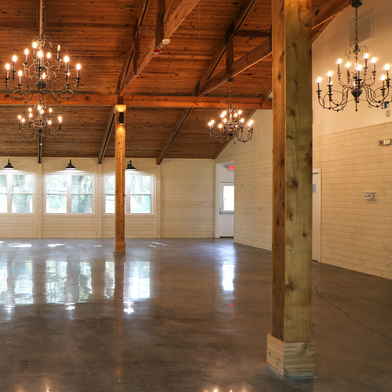Striking wood columns attached to the buffed concrete floor inside the Sherlock Springs Lodge